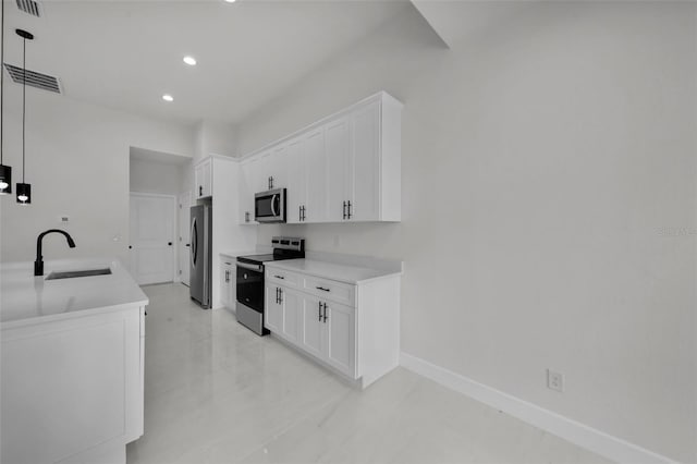 14009 Wenzel Ave, Port Charlotte, FL 33981 - kitchen with appliances with stainless steel finishes, a sink, recessed lighting, white cabinetry, and baseboards