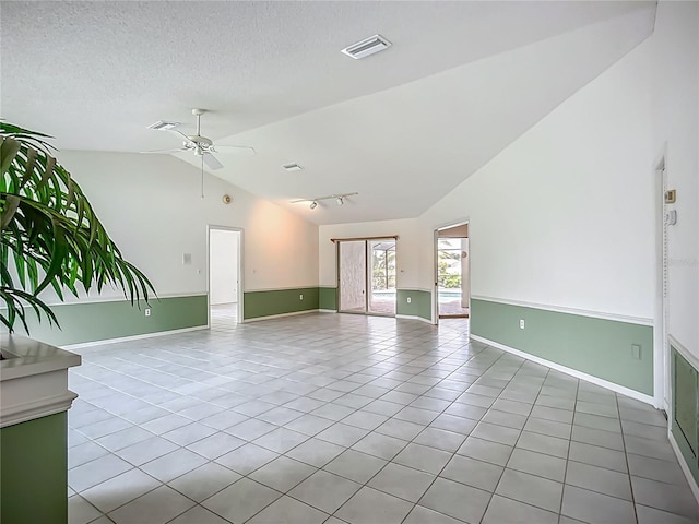 8822 Misty Creek Dr, Sarasota, FL 34241 - unfurnished room featuring light tile patterned floors, a ceiling fan, baseboards, high vaulted ceiling, and a textured ceiling