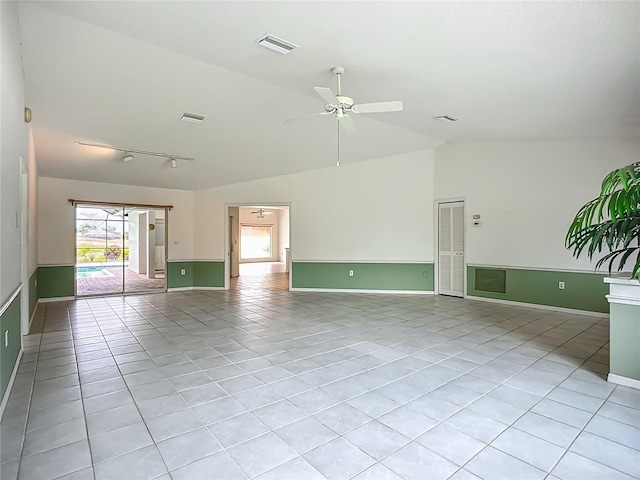 8822 Misty Creek Dr, Sarasota, FL 34241 - unfurnished room featuring vaulted ceiling, light tile patterned floors, ceiling fan, baseboards, and track lighting
