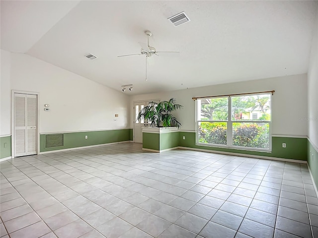 8822 Misty Creek Dr, Sarasota, FL 34241 - spare room with vaulted ceiling, tile patterned flooring, a ceiling fan, and baseboards