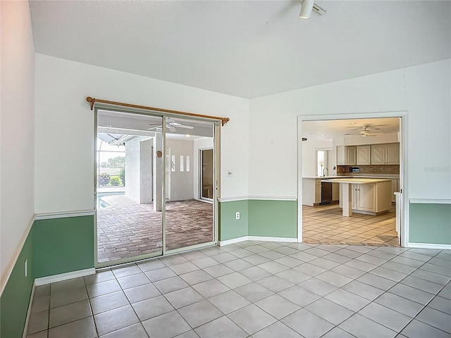 8822 Misty Creek Dr, Sarasota, FL 34241 - empty room with a ceiling fan, light tile patterned flooring, and baseboards
