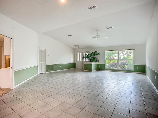 8822 Misty Creek Dr, Sarasota, FL 34241 - empty room with vaulted ceiling, light tile patterned floors, a ceiling fan, and baseboards