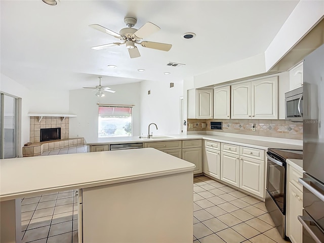 8822 Misty Creek Dr, Sarasota, FL 34241 - kitchen featuring a sink, appliances with stainless steel finishes, backsplash, ceiling fan, and light countertops
