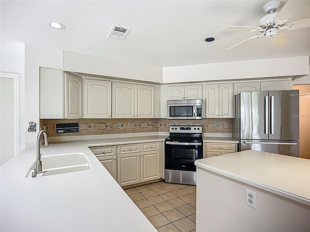 8822 Misty Creek Dr, Sarasota, FL 34241 - kitchen with appliances with stainless steel finishes, a sink, light countertops, tasteful backsplash, and light tile patterned floors