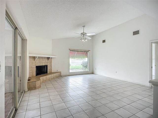 8822 Misty Creek Dr, Sarasota, FL 34241 - unfurnished living room with a ceiling fan, light tile patterned floors, a tile fireplace, a textured ceiling, and high vaulted ceiling