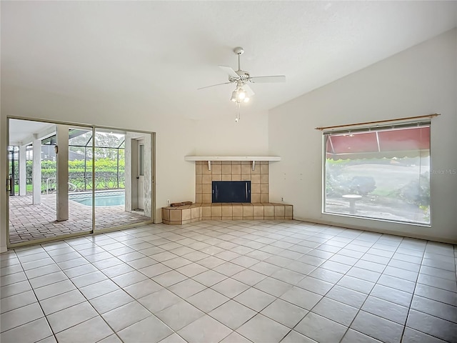 8822 Misty Creek Dr, Sarasota, FL 34241 - unfurnished living room with lofted ceiling, tile patterned floors, ceiling fan, and a tiled fireplace