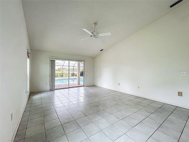 8822 Misty Creek Dr, Sarasota, FL 34241 - spare room with lofted ceiling, light tile patterned floors, ceiling fan, a textured ceiling, and baseboards