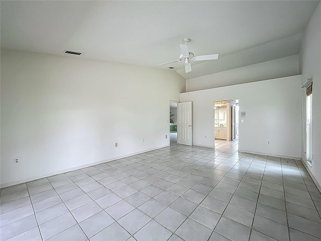 8822 Misty Creek Dr, Sarasota, FL 34241 - spare room with light tile patterned floors, lofted ceiling, a ceiling fan, and baseboards