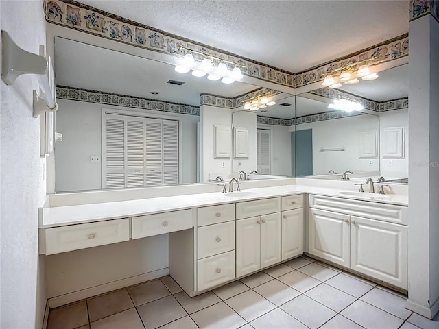 8822 Misty Creek Dr, Sarasota, FL 34241 - full bathroom with double vanity, tile patterned flooring, and a textured ceiling