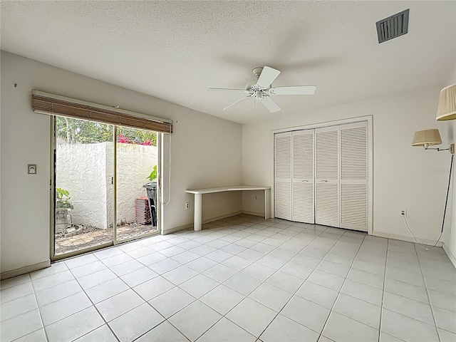 8822 Misty Creek Dr, Sarasota, FL 34241 - unfurnished bedroom featuring access to outside, a closet, ceiling fan, a textured ceiling, and baseboards