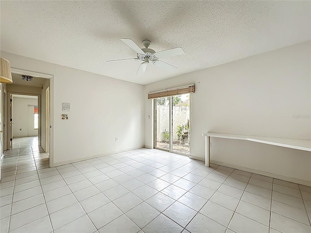8822 Misty Creek Dr, Sarasota, FL 34241 - spare room featuring a ceiling fan, light tile patterned flooring, a textured ceiling, and baseboards