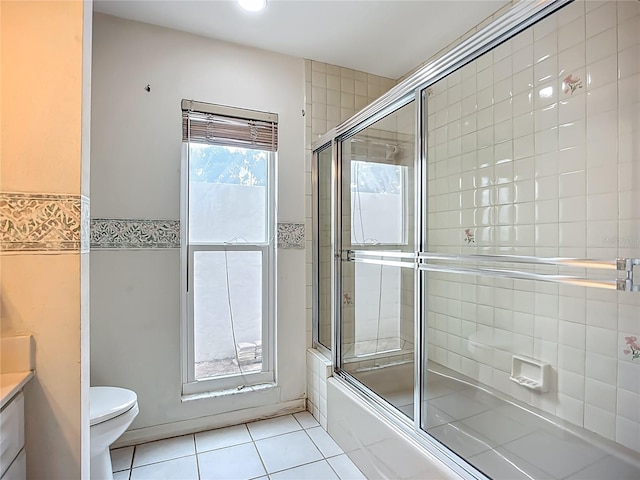 8822 Misty Creek Dr, Sarasota, FL 34241 - full bathroom with shower / bath combination with glass door, toilet, tile patterned floors, vanity, and tile walls