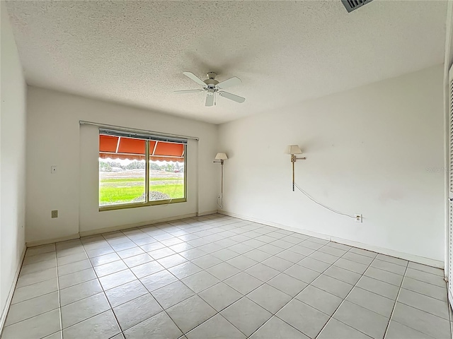 8822 Misty Creek Dr, Sarasota, FL 34241 - empty room featuring ceiling fan, a textured ceiling, and light tile patterned floors