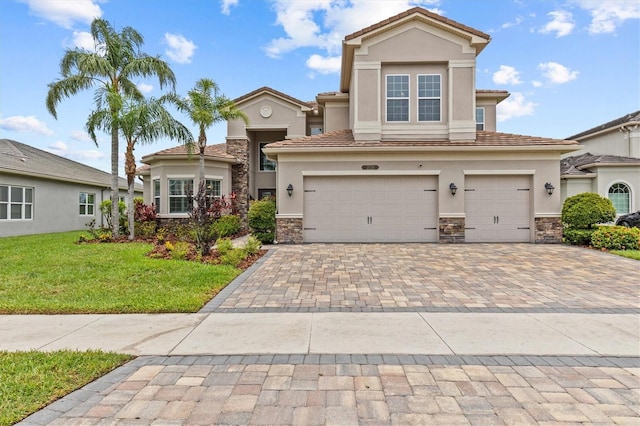 2724 Coco Palm Cir, Wesley Chapel, FL 33543 - view of front of property featuring stucco siding, stone siding, and decorative driveway