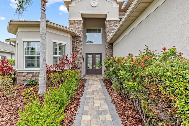 2724 Coco Palm Cir, Wesley Chapel, FL 33543 - view of exterior entry featuring stucco siding, french doors, and stone siding