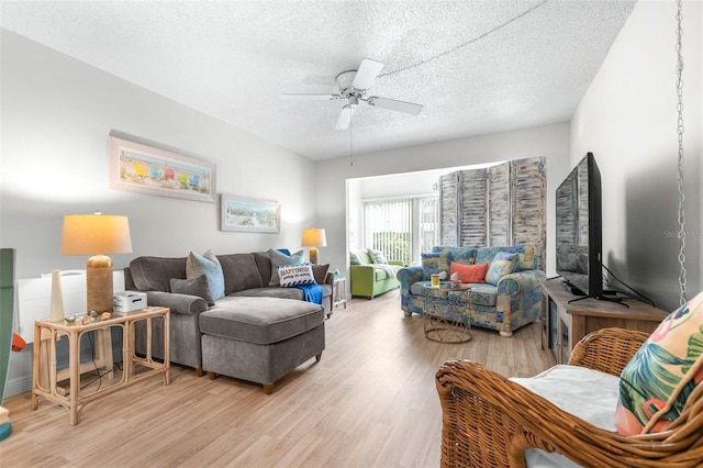 2060 Marilyn St Unit 114, Clearwater, FL 33765 - living room with light wood-style floors, a ceiling fan, a textured ceiling, and baseboards
