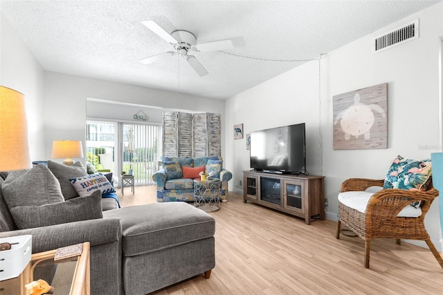 2060 Marilyn St Unit 114, Clearwater, FL 33765 - living area featuring light wood-style floors, ceiling fan, a textured ceiling, and baseboards