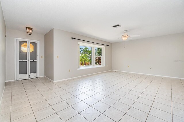 1839 Neptune Dr, Englewood, FL 34223 - empty room featuring a ceiling fan, baseboards, and light tile patterned floors