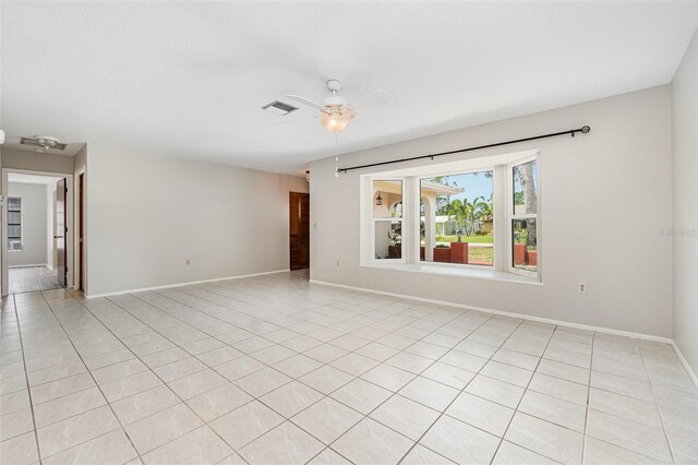 1839 Neptune Dr, Englewood, FL 34223 - empty room featuring a ceiling fan, baseboards, and light tile patterned flooring