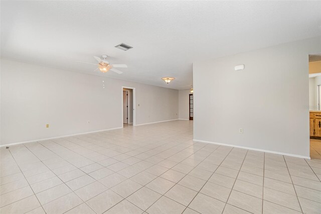 1839 Neptune Dr, Englewood, FL 34223 - empty room with a ceiling fan, baseboards, and light tile patterned floors