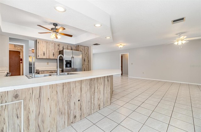 1839 Neptune Dr, Englewood, FL 34223 - kitchen featuring stainless steel fridge, a ceiling fan, light countertops, a sink, and recessed lighting