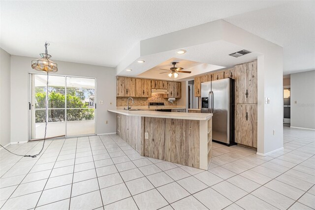 1839 Neptune Dr, Englewood, FL 34223 - kitchen featuring stainless steel fridge, electric range, light countertops, a peninsula, and light tile patterned floors