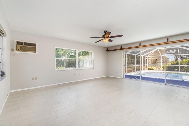 1839 Neptune Dr, Englewood, FL 34223 - spare room with a ceiling fan, a wall mounted air conditioner, baseboards, and a sunroom