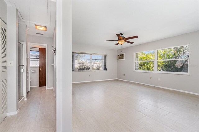 1839 Neptune Dr, Englewood, FL 34223 - unfurnished room featuring a ceiling fan, attic access, a wall mounted AC, and baseboards
