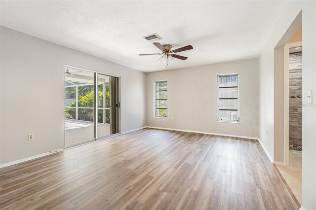 1839 Neptune Dr, Englewood, FL 34223 - spare room with a ceiling fan, light wood-style flooring, and baseboards