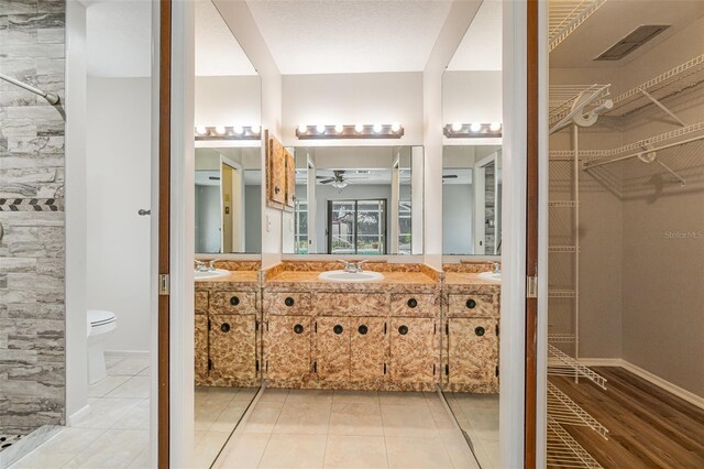 1839 Neptune Dr, Englewood, FL 34223 - full bathroom with a ceiling fan, toilet, vanity, and a spacious closet