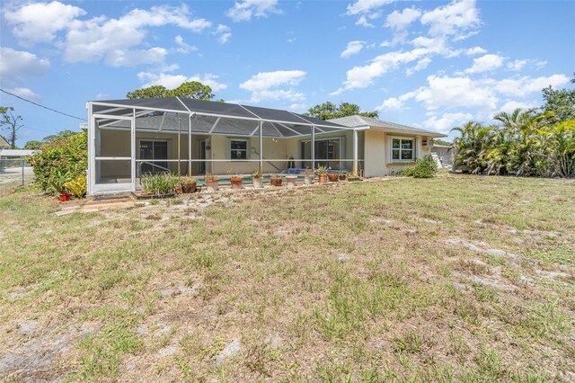 1839 Neptune Dr, Englewood, FL 34223 - rear view of house with a lawn and a lanai