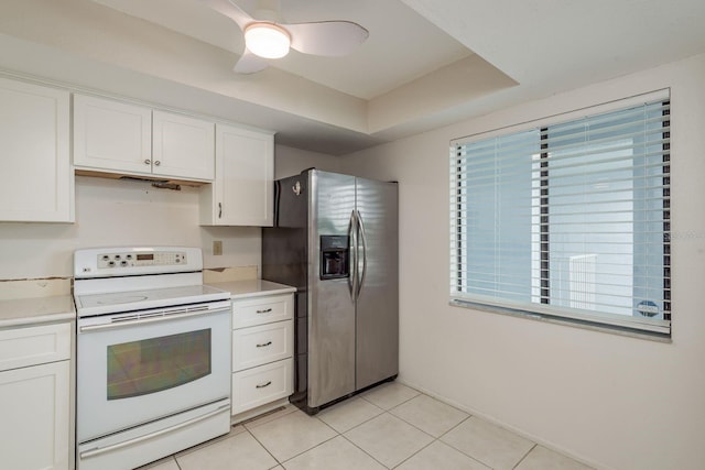 210 Martha Ln Unit 210, Oldsmar, FL 34677 - kitchen featuring white electric stove, stainless steel refrigerator with ice dispenser, light tile patterned floors, white cabinetry, and light countertops
