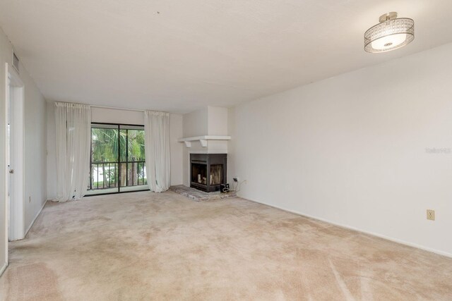 210 Martha Ln Unit 210, Oldsmar, FL 34677 - unfurnished living room featuring a fireplace with raised hearth and carpet flooring