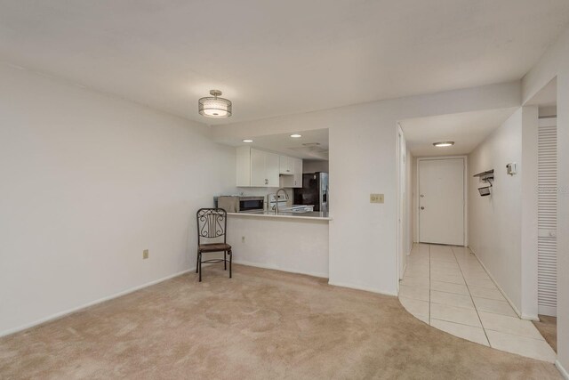 210 Martha Ln Unit 210, Oldsmar, FL 34677 - unfurnished living room with light carpet, light tile patterned flooring, baseboards, and recessed lighting