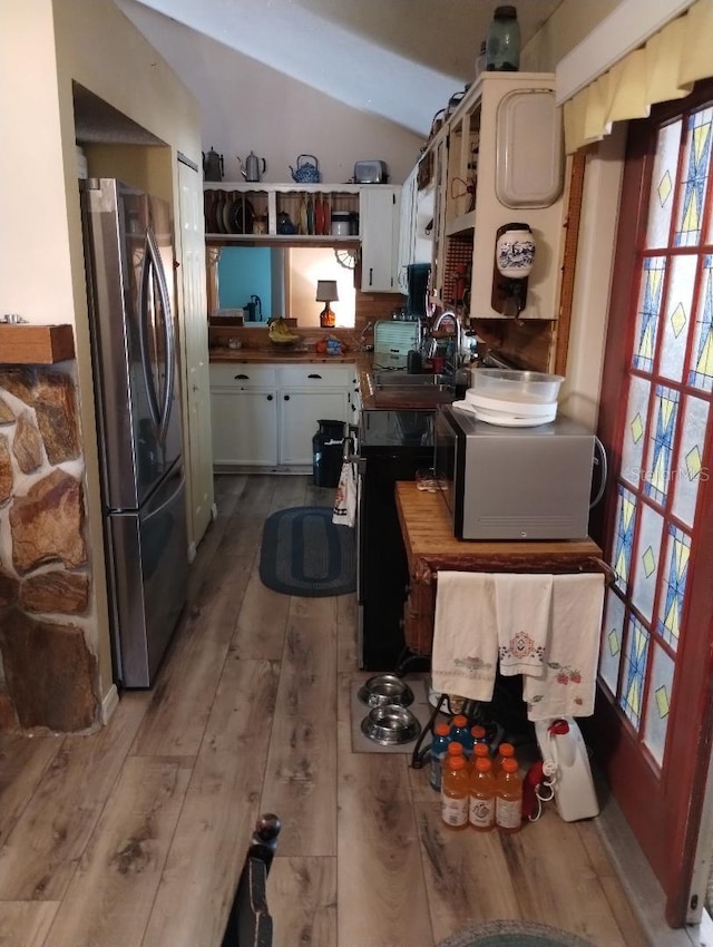 7608 Chenkin, Zephyrhills, FL 33540 - kitchen with freestanding refrigerator, lofted ceiling, hardwood / wood-style flooring, a sink, and open shelves