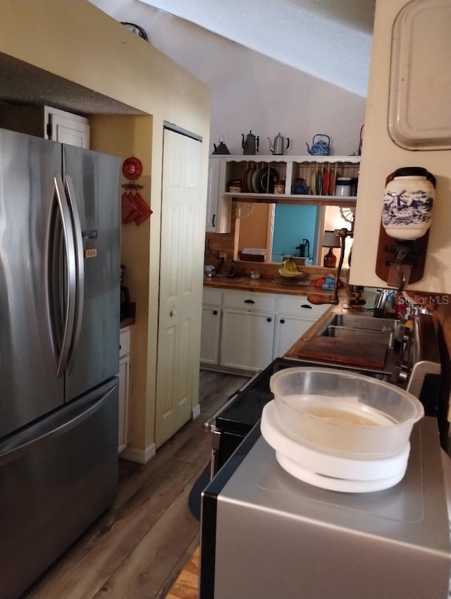 7608 Chenkin, Zephyrhills, FL 33540 - kitchen with freestanding refrigerator, white cabinetry, wood finished floors, dark countertops, and open shelves