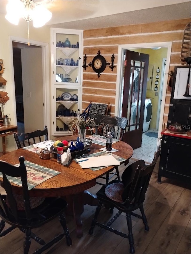 7608 Chenkin, Zephyrhills, FL 33540 - dining space featuring washer / clothes dryer, wood finished floors, and rustic walls