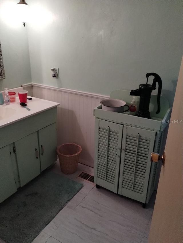 7608 Chenkin, Zephyrhills, FL 33540 - bathroom with wainscoting, vanity, and marble finish flooring