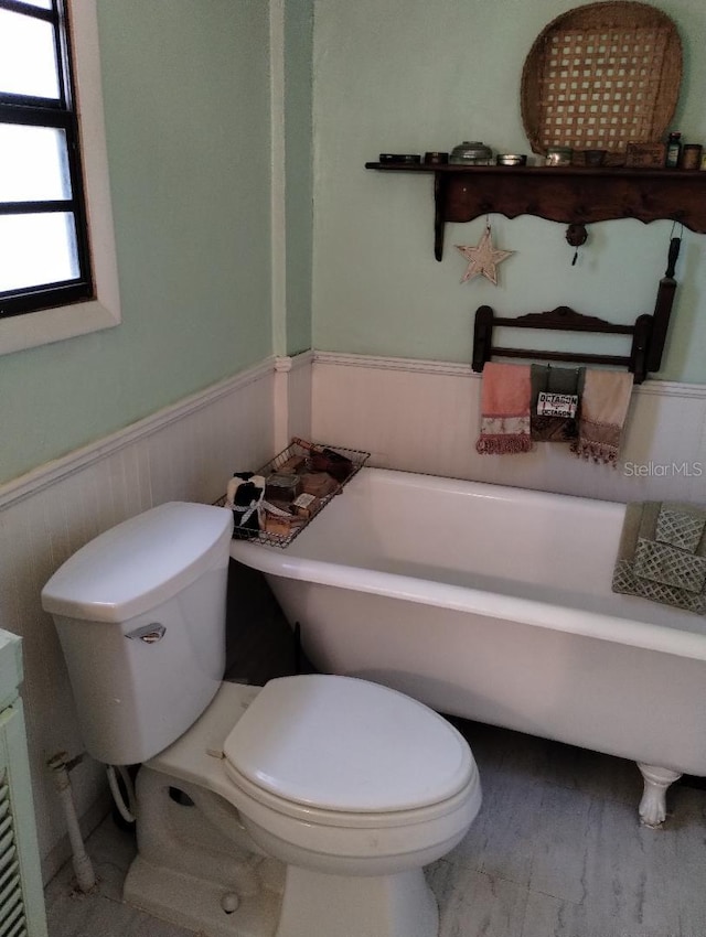 7608 Chenkin, Zephyrhills, FL 33540 - full bathroom with a freestanding tub, wainscoting, and toilet