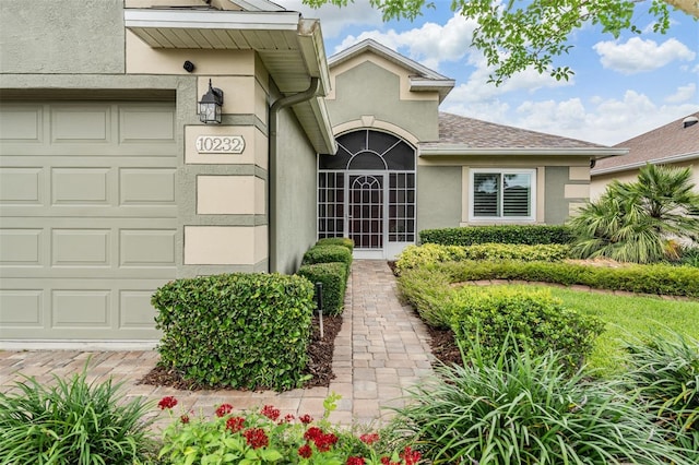 10232 Buncombe Way, San Antonio, FL 33576 - property entrance with stucco siding and an attached garage