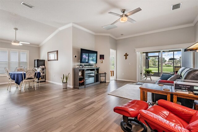10232 Buncombe Way, San Antonio, FL 33576 - living room featuring ceiling fan, ornamental molding, wood finished floors, baseboards, and lofted ceiling