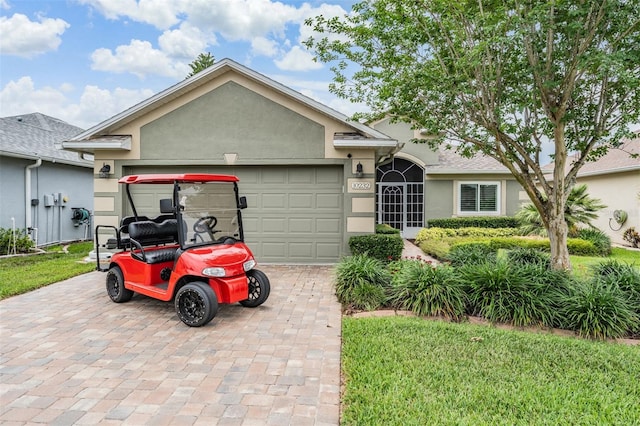 10232 Buncombe Way, San Antonio, FL 33576 - ranch-style home featuring stucco siding, an attached garage, and decorative driveway