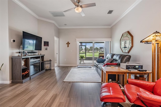 10232 Buncombe Way, San Antonio, FL 33576 - living room featuring crown molding, a ceiling fan, wood finished floors, baseboards, and a fireplace