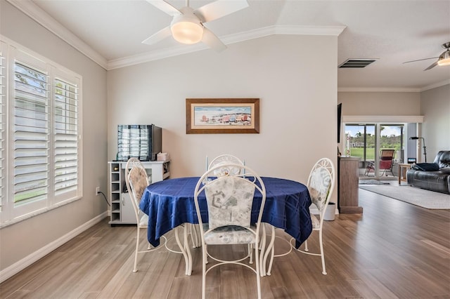 10232 Buncombe Way, San Antonio, FL 33576 - dining room with ceiling fan, wood finished floors, baseboards, and ornamental molding