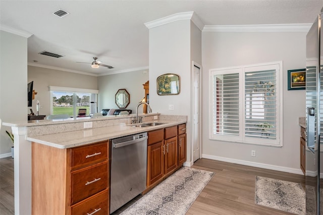 10232 Buncombe Way, San Antonio, FL 33576 - kitchen with dishwasher, a sink, a peninsula, light wood-type flooring, and brown cabinetry