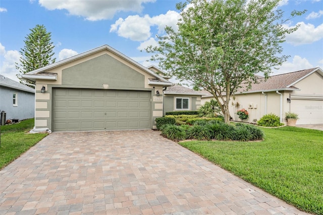 10232 Buncombe Way, San Antonio, FL 33576 - single story home with stucco siding, a front yard, decorative driveway, and an attached garage