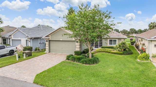 10232 Buncombe Way, San Antonio, FL 33576 - view of front of property featuring decorative driveway, a garage, stucco siding, and a front lawn
