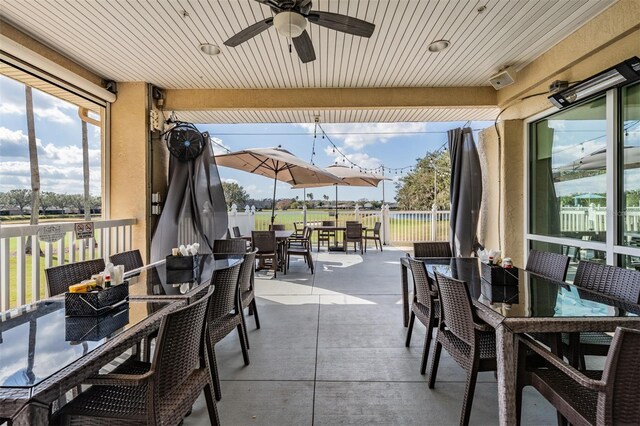 10232 Buncombe Way, San Antonio, FL 33576 - view of patio / terrace with outdoor dining area, a ceiling fan, and an outdoor hangout area
