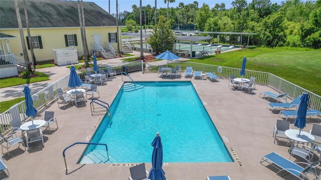 10232 Buncombe Way, San Antonio, FL 33576 - community pool with a patio and outdoor dining area