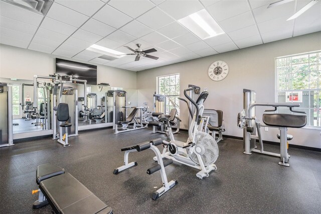 10232 Buncombe Way, San Antonio, FL 33576 - gym featuring a paneled ceiling, ceiling fan, and baseboards